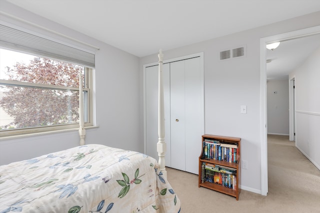 carpeted bedroom featuring visible vents