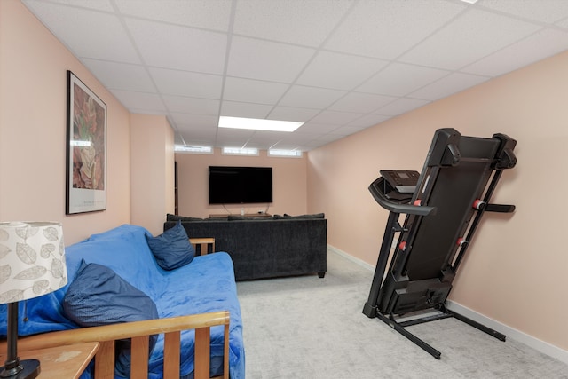 exercise room with baseboards, carpet flooring, and a paneled ceiling