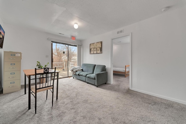 living room featuring carpet floors, baseboards, a textured ceiling, and visible vents