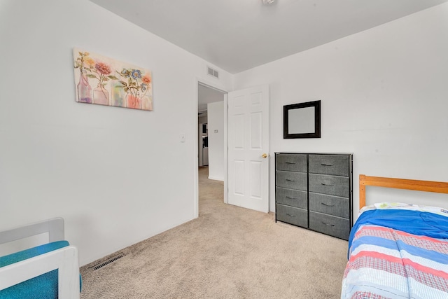 bedroom with visible vents, carpet flooring, and heating unit