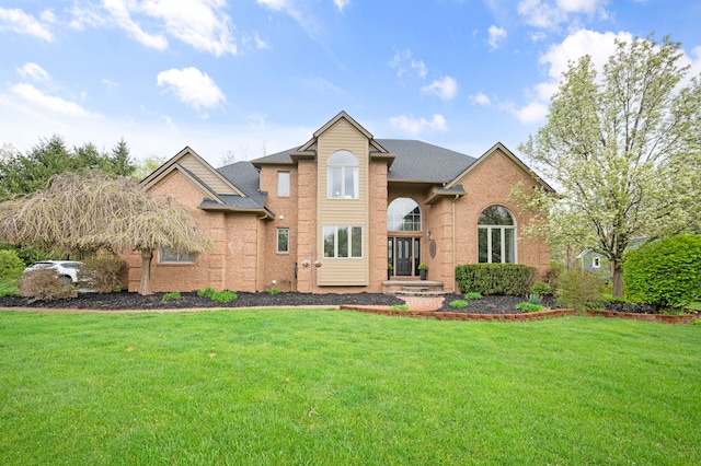 10348 Londonderry Dr, South Lyon, MI 48178 - view of front of property with a front yard, brick siding, and a shingled roof