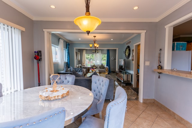 dining room with crown molding, baseboards, light tile patterned flooring, and visible vents