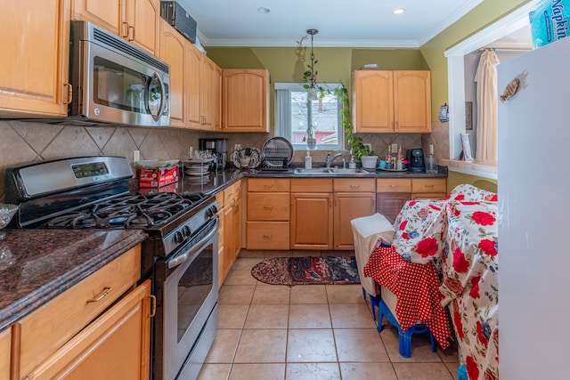 kitchen featuring backsplash, crown molding, appliances with stainless steel finishes, light brown cabinetry, and a sink