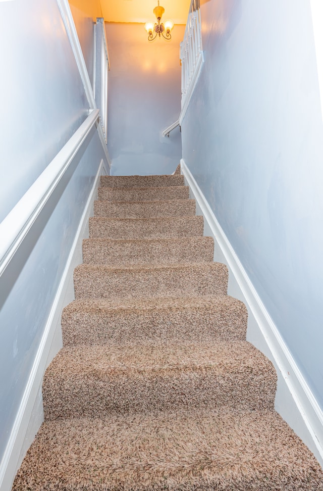 stairway with an inviting chandelier