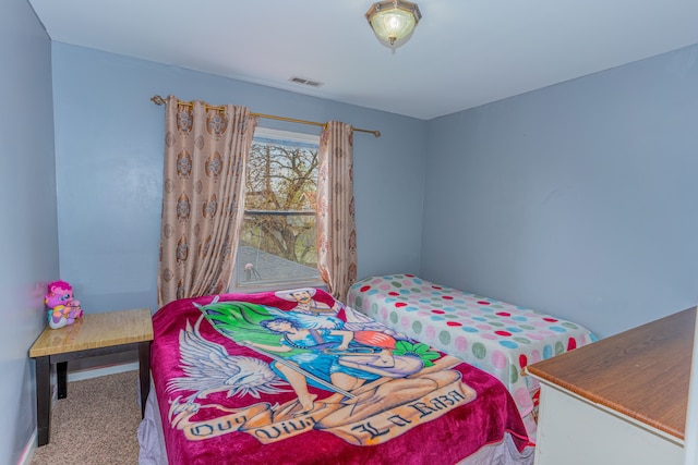 bedroom featuring visible vents, carpet, and baseboards