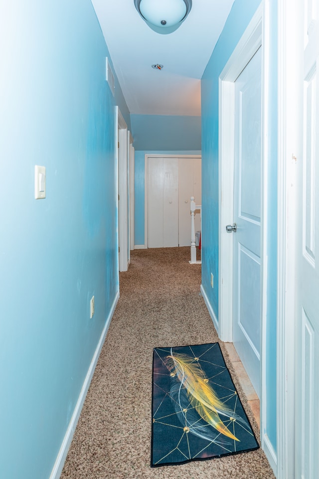 hall with carpet floors and baseboards