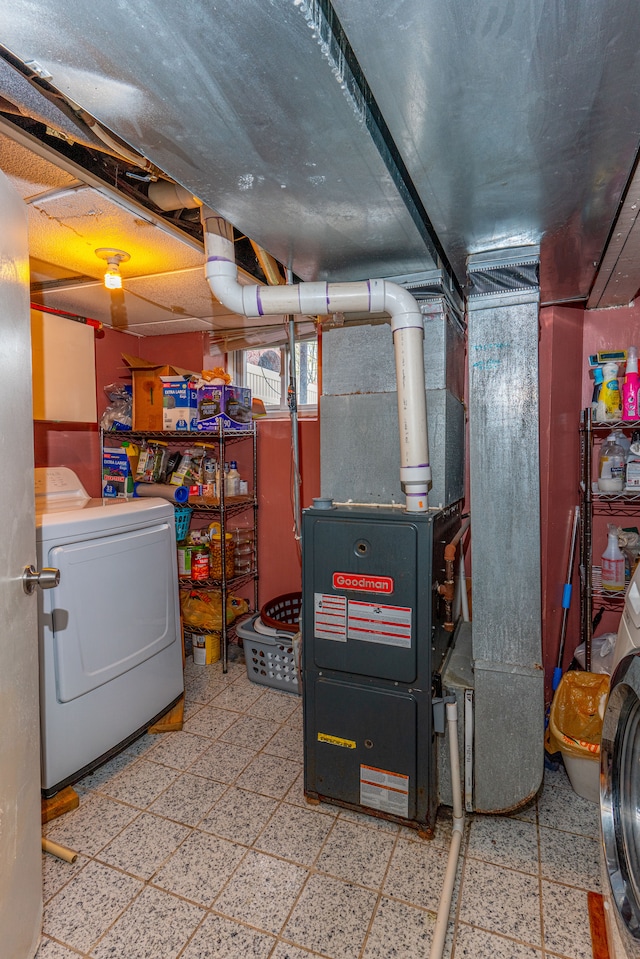 below grade area featuring separate washer and dryer and tile patterned floors