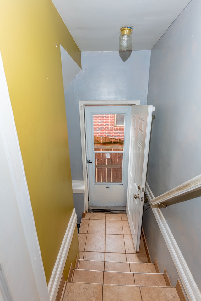 doorway featuring light tile patterned flooring