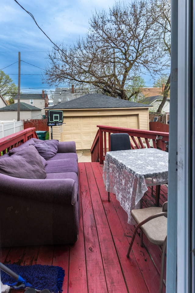 wooden terrace featuring fence, an outdoor structure, and outdoor dining space
