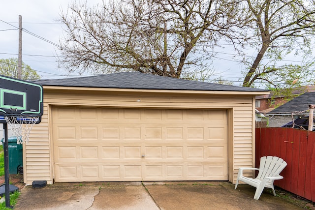 detached garage featuring fence