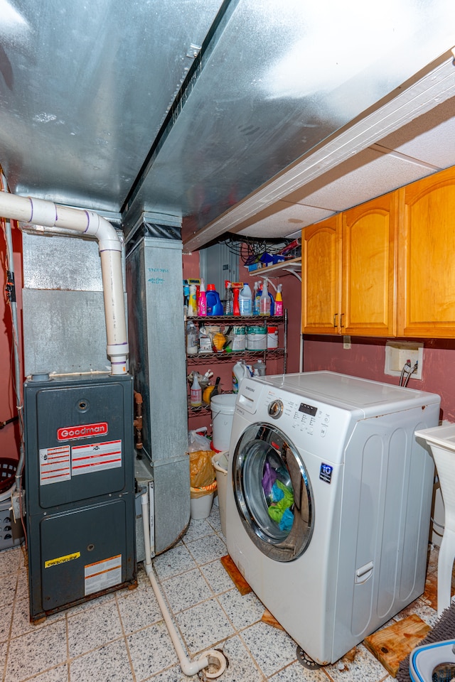 laundry room featuring light floors, washer / dryer, and cabinet space