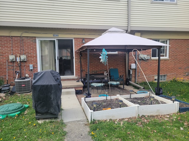 3022 Wolverine Dr, Ann Arbor, MI 48108 - view of patio / terrace featuring area for grilling, a vegetable garden, a gazebo, and central AC