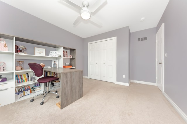 office space featuring baseboards, ceiling fan, light carpet, and visible vents