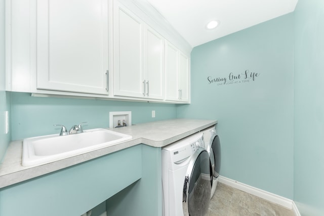 laundry room with washing machine and dryer, a sink, cabinet space, baseboards, and recessed lighting