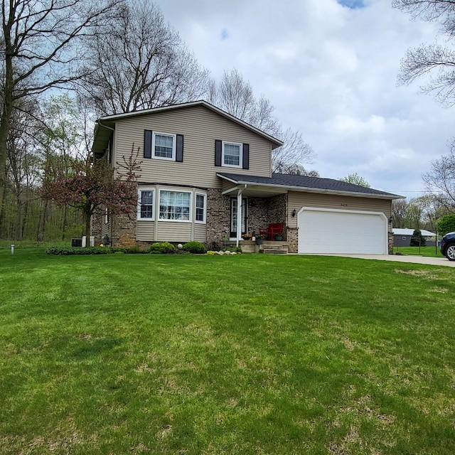 traditional-style house with a garage, driveway, and a front lawn