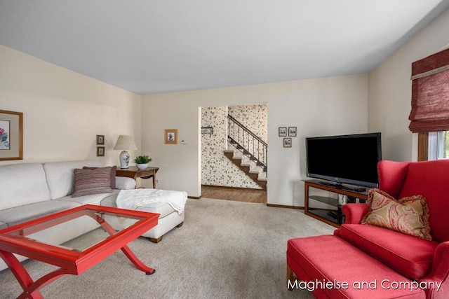 living room with carpet, stairs, and baseboards