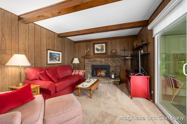 carpeted living room featuring wooden walls, beamed ceiling, and a fireplace