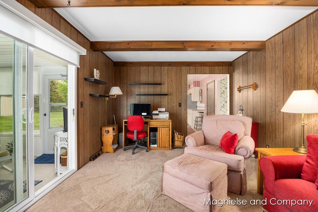 home office featuring wooden walls, carpet flooring, and beam ceiling