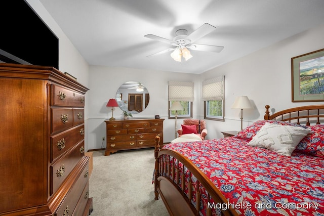 bedroom featuring light carpet and a ceiling fan