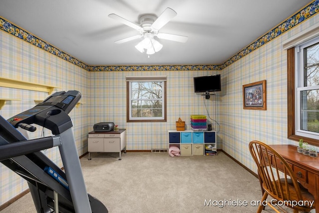 exercise room featuring carpet, ceiling fan, and baseboards