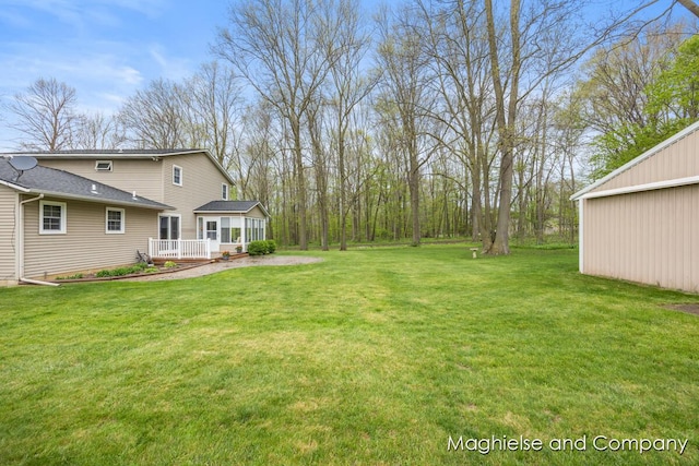 view of grassy yard featuring a wooden deck