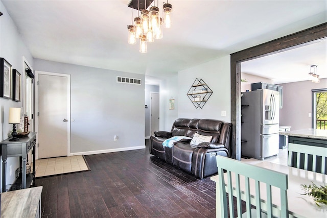 3687 Steinacker Rd, Howell, MI 48855 - living room with hardwood / wood-style floors, a chandelier, and baseboards