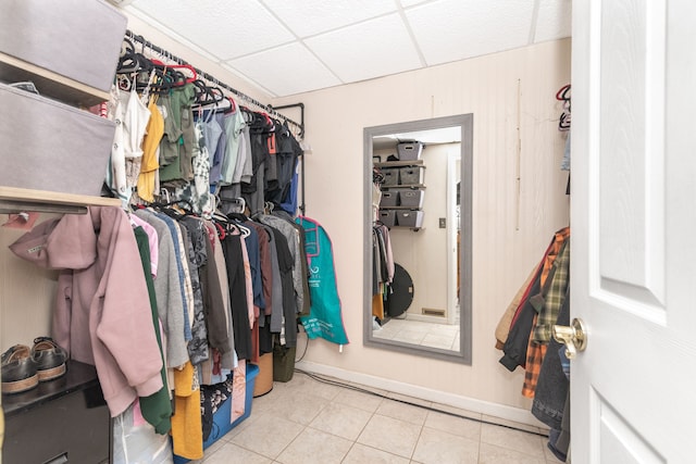 spacious closet with tile patterned floors and a paneled ceiling