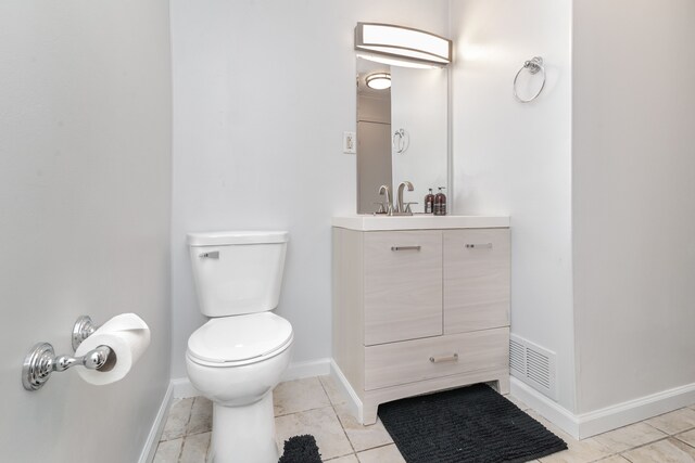 bathroom featuring toilet, baseboards, visible vents, tile patterned floors, and vanity