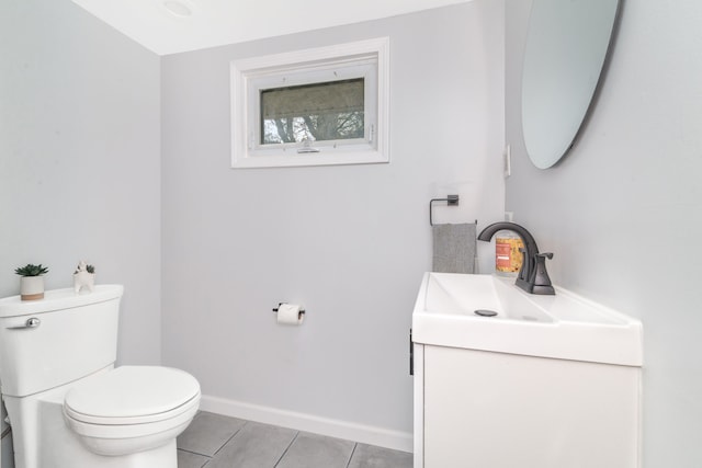 half bath featuring toilet, baseboards, tile patterned floors, and vanity