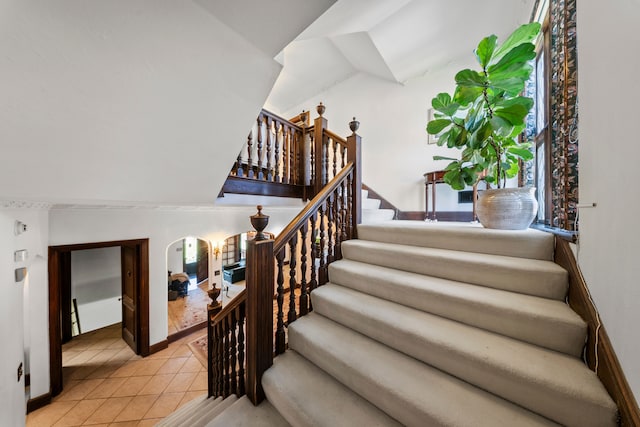 725 W Boston Blvd, Detroit, MI 48202 - staircase with baseboards, tile patterned floors, and vaulted ceiling