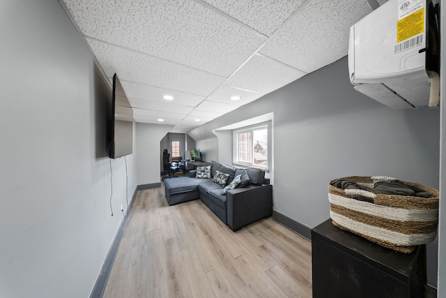 725 W Boston Blvd, Detroit, MI 48202 - living area featuring a wall unit AC, light wood-type flooring, baseboards, a drop ceiling, and recessed lighting