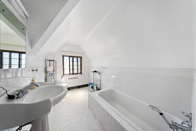 725 W Boston Blvd, Detroit, MI 48202 - full bath featuring tile patterned flooring, lofted ceiling, tile walls, a bath, and a wainscoted wall