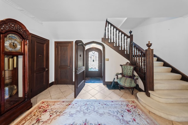 725 W Boston Blvd, Detroit, MI 48202 - foyer entrance with light tile patterned floors, arched walkways, baseboards, and stairs