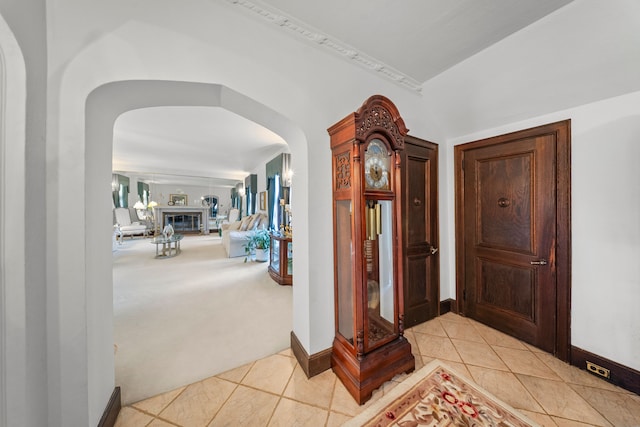 725 W Boston Blvd, Detroit, MI 48202 - entryway featuring arched walkways, baseboards, light tile patterned flooring, and light colored carpet