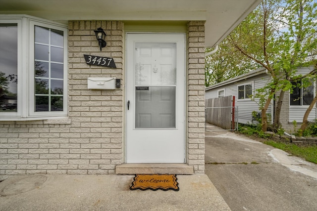 view of exterior entry with fence