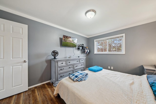 bedroom with baseboards, ornamental molding, and dark wood-style floors