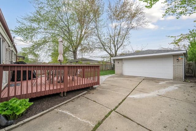 exterior space featuring an outdoor structure, a detached garage, and fence