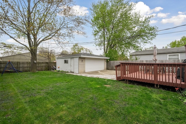 view of yard featuring an outdoor structure, a deck, a garage, and a fenced backyard