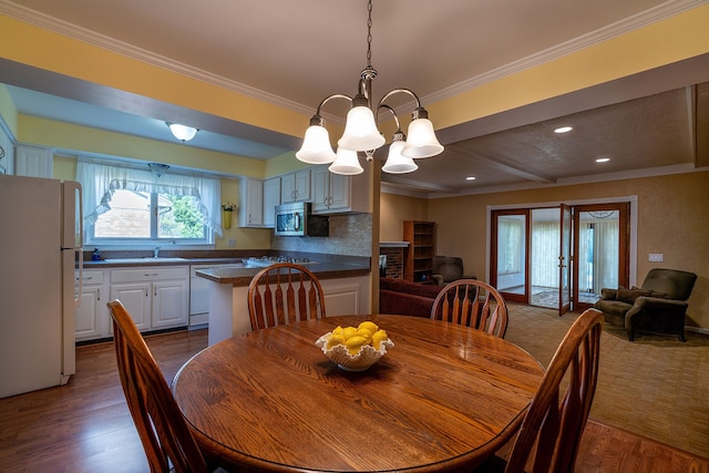 6228 Atkins Dr, Troy, MI 48085 - dining space with a chandelier, ornamental molding, dark wood-style floors, recessed lighting, and beam ceiling