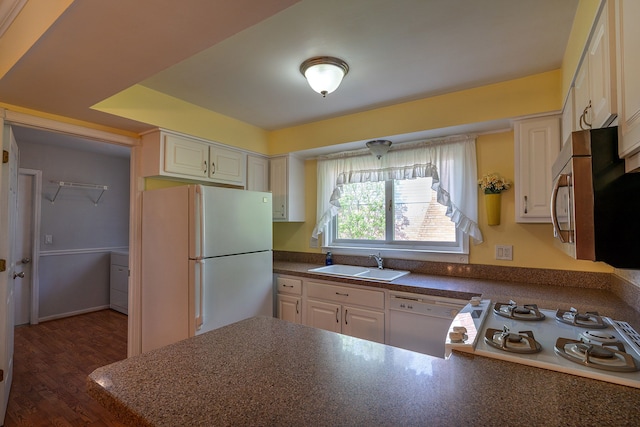 6228 Atkins Dr, Troy, MI 48085 - kitchen with a sink, white appliances, dark countertops, white cabinetry, and dark wood-type flooring