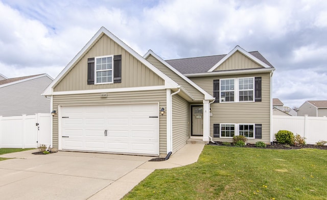 view of front facade with concrete driveway, board and batten siding, a front lawn, and fence