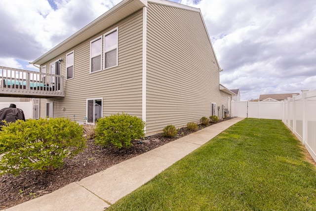 view of side of property with a yard and a fenced backyard