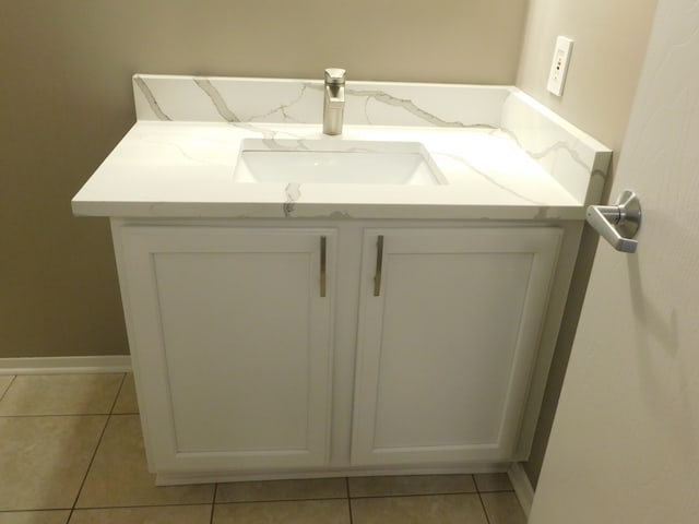 bathroom featuring tile patterned floors, baseboards, and vanity