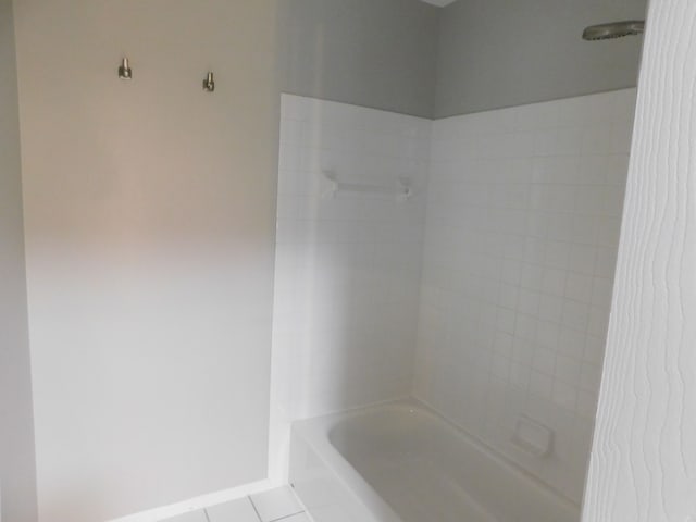 bathroom with tile patterned floors and shower / bathtub combination