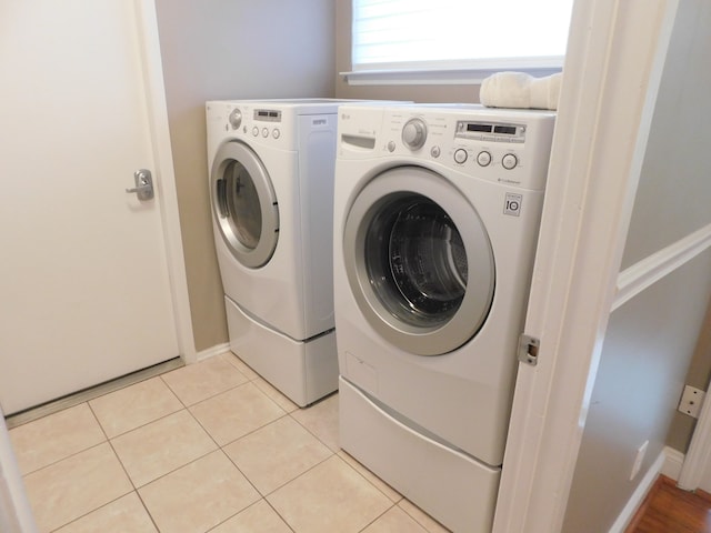 laundry area featuring laundry area, independent washer and dryer, and light tile patterned flooring