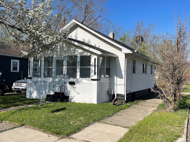 97 N Roselawn St, Pontiac, MI 48342 - bungalow with entry steps, a chimney, and a front yard