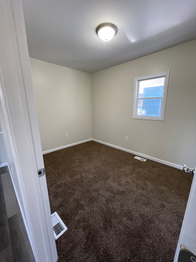 97 N Roselawn St, Pontiac, MI 48342 - unfurnished room with baseboards, dark carpet, and visible vents