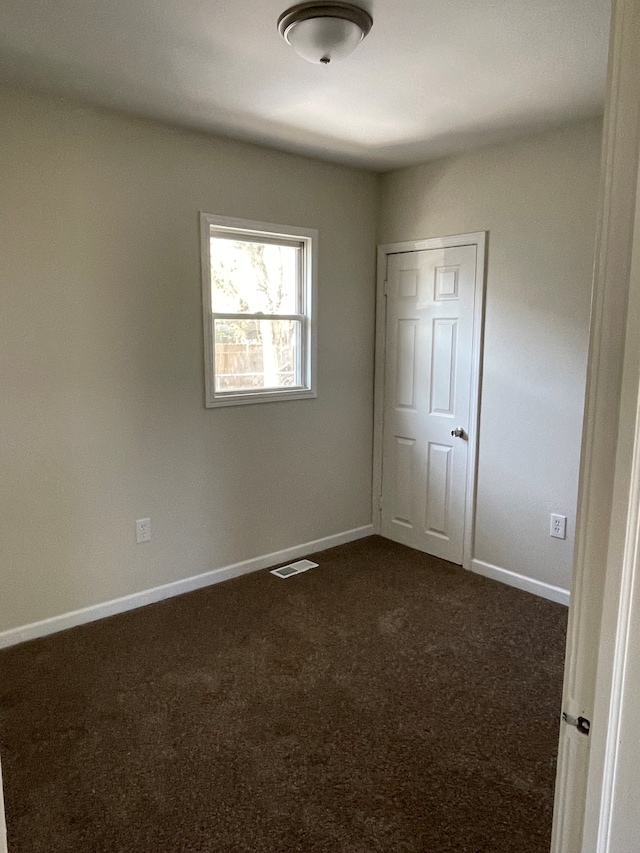 97 N Roselawn St, Pontiac, MI 48342 - unfurnished bedroom with baseboards, visible vents, and dark carpet