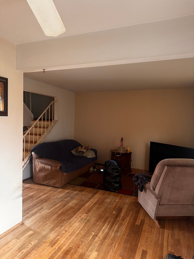 living area with stairs and wood finished floors