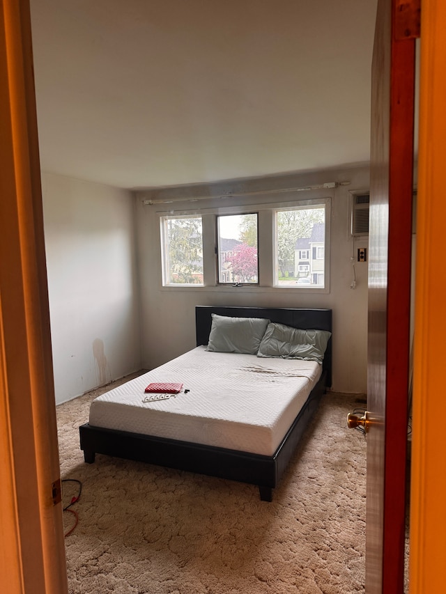 bedroom featuring carpet and a wall mounted air conditioner